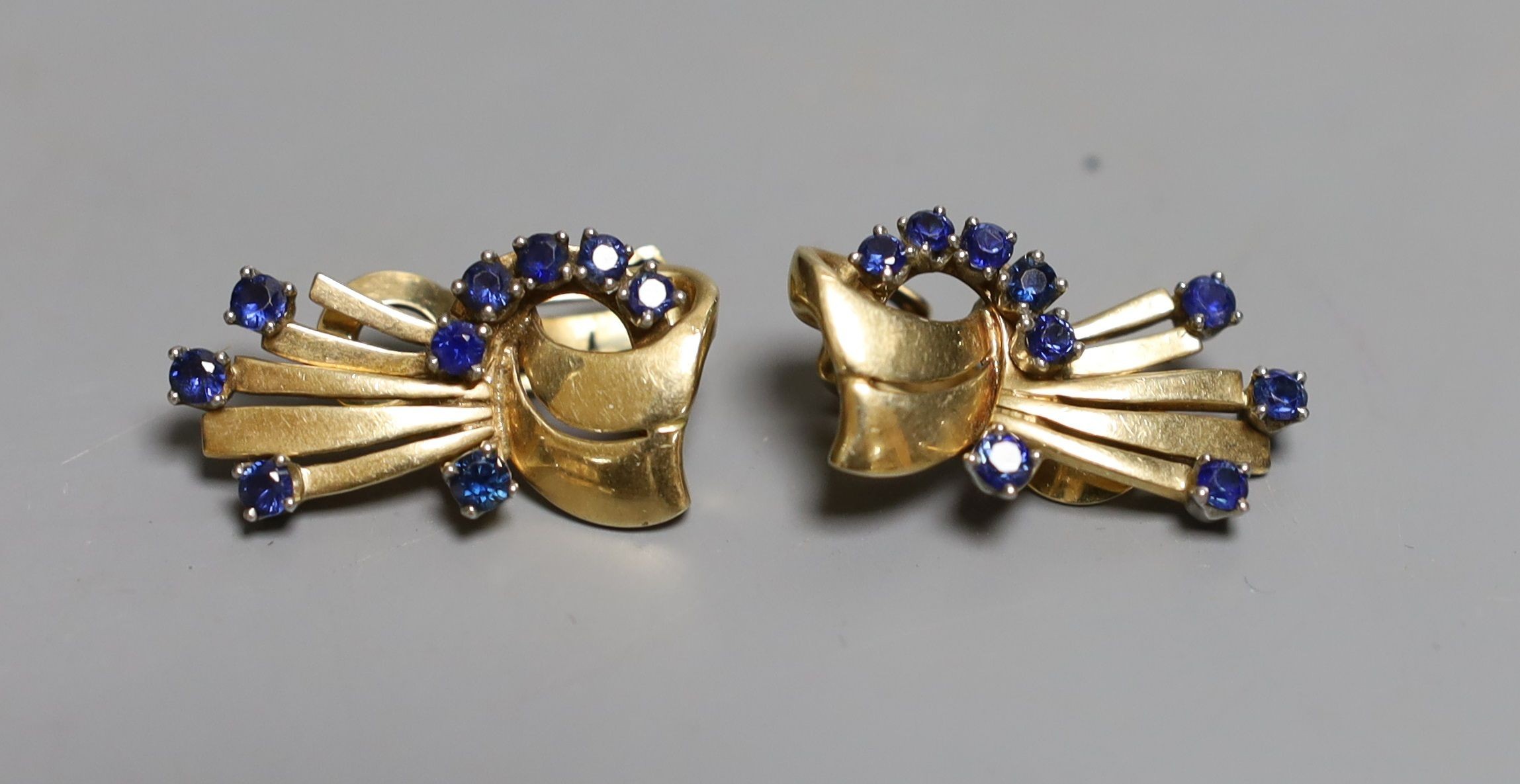 A stylish pair of mid 20th century yellow metal and sapphire cluster set fan shaped ear clips, 27mm, gross weight 15.6 grams.